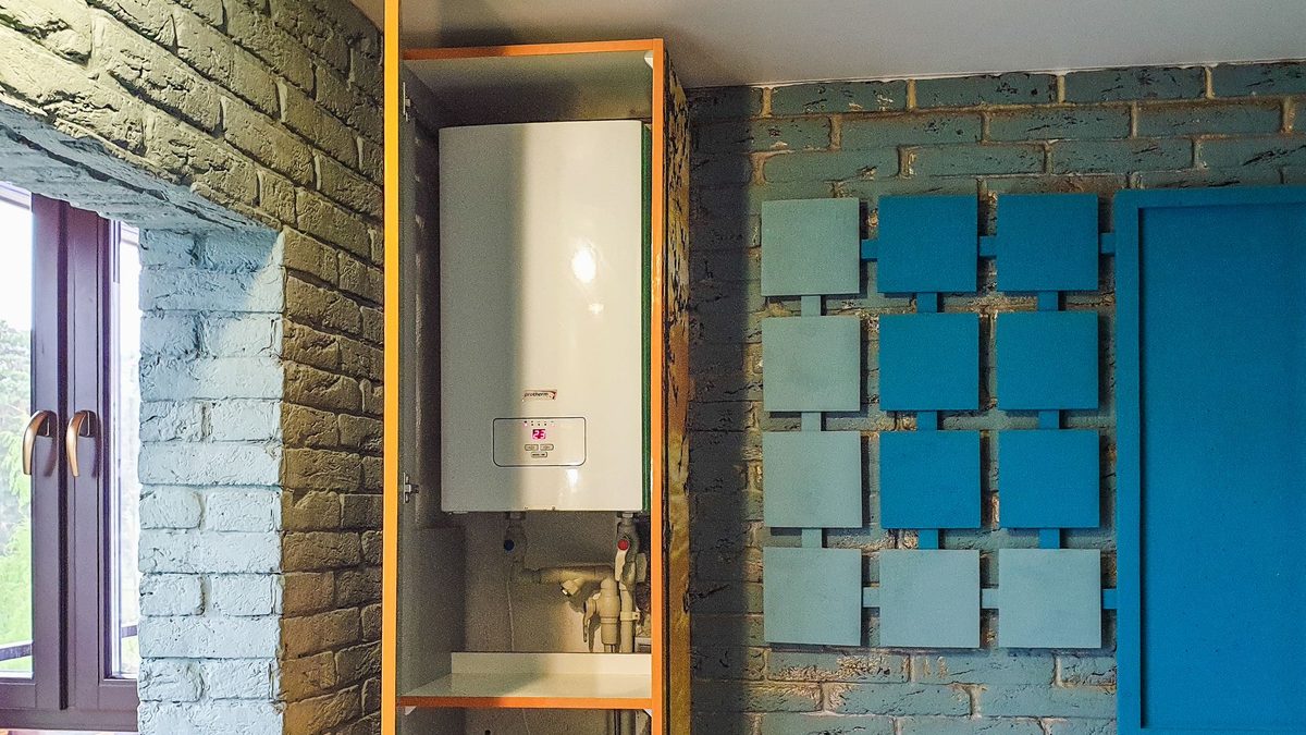 Gray water heater installed inside a fitted cabinet